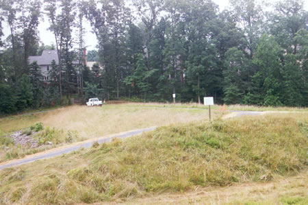 The trail loops back up to and crosses a dam.