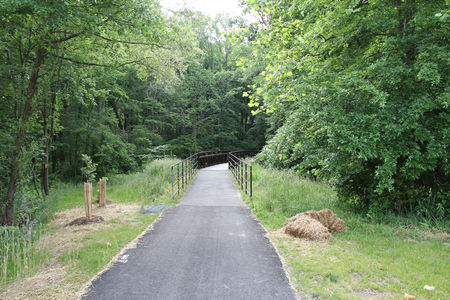 The trail crosses a bridge over a stream.