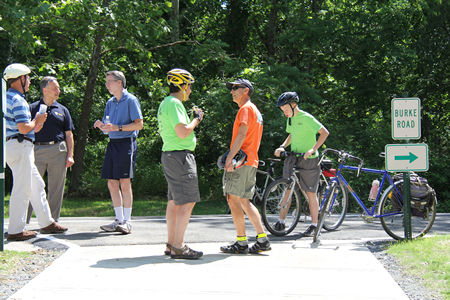 Turn right along the intersecting road. The people attended the trail opening on June 2, 2012.