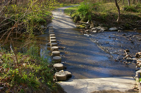 The trail crosses Pohick Creek on columns.