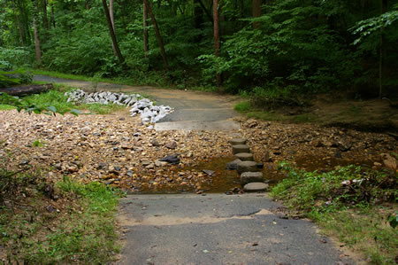 The trail makes a stream crossing on columns.