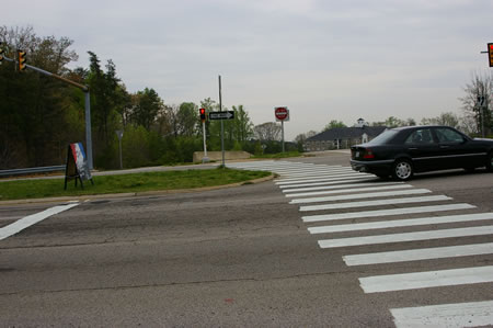 Use the crosswalks to cross Rolling Road and the ramp from the Parkway. There is a walk light for the Rolling Road crossing.
