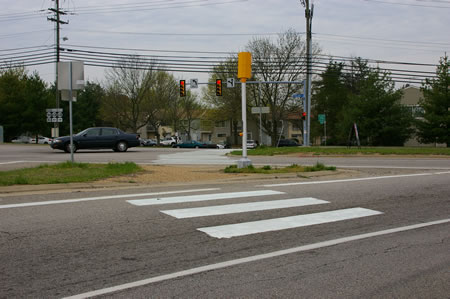 Use the crosswalks to cross the ramp from the Parkway and Rolling Road. There is a walk light for Rolling Road.