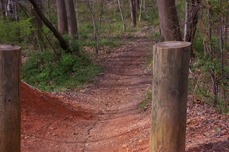 The trail descends a steep hill.