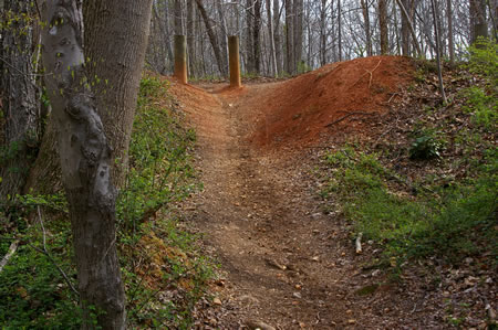 The trail climbs a steep hill.