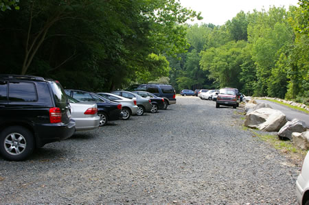 The parking area is filled during pool season weekends.
