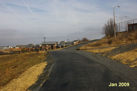 Follow the asphalt trail up the hill with the pumping station on the left.