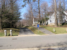 The trail crosses Grenwich Point Rd.  Notice that the trail is to the right of the driveway at the street crossing.