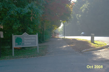 Walk across the school driveway and past the asphalt trail to the left.