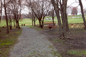 The gravel path continues through the picnic grounds.