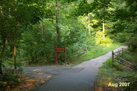 An asphalt trail intersects from the left.  Turn left and follow that trail.