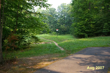 Walk to the end of the paved trail. Turn left onto the gravel trail. Do not continue straight on the dirt trail .