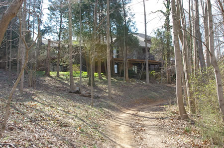 The trail climbs a hill and passes near this house.