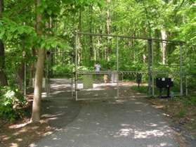 Pass through the pedestrian gate on the left side of the trail.